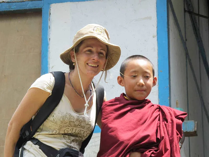 We connect cultures. Here Helen with a budding local monk in West-Sikkim Image