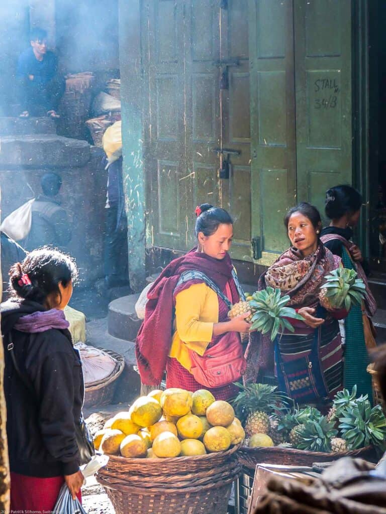 Women from Meghalaya select pineapples at the local market